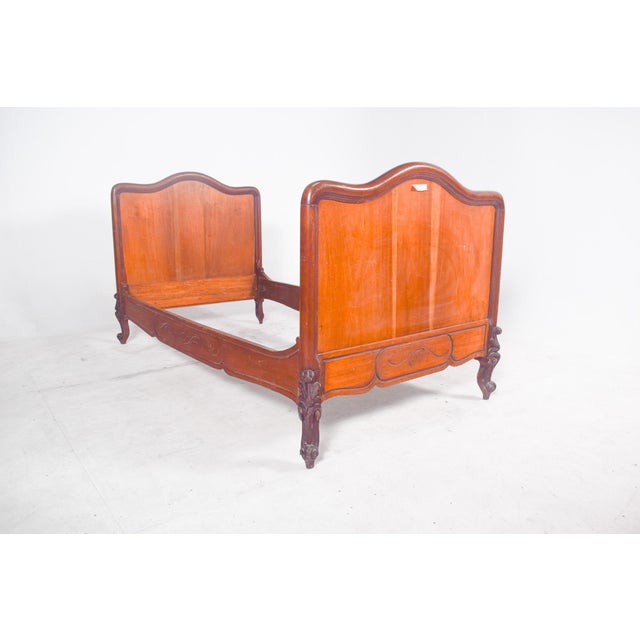 This single bed is a fine French piece in the Louis XV style, crafted from solid wood and veneered in mahogany. The design...