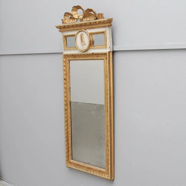A special wooden wall mirror. The good piece wears a seal on the back and dates from the last half of the 18th century....