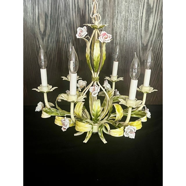This charming, mid-century tole six-arm chandelier appears to be constructed out of leaves and is decorated with delicate...