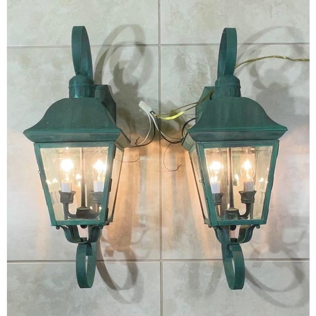Elegant pair of solid brass wall lanterns. featuring a timeless French Quarter-inspired design. The lanterns feature a...