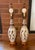 A striking pair of vintage Mid-Century Modern ceramic table lamps featuring an intricately pierced cutout design and...