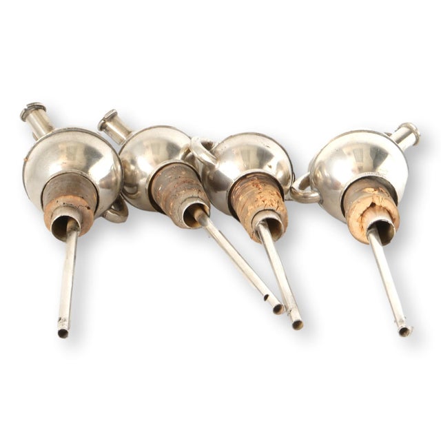 Set of four midcentury Art Deco Style French silverplate liquor pourers with spherical bodies, elongated spouts, and cork...