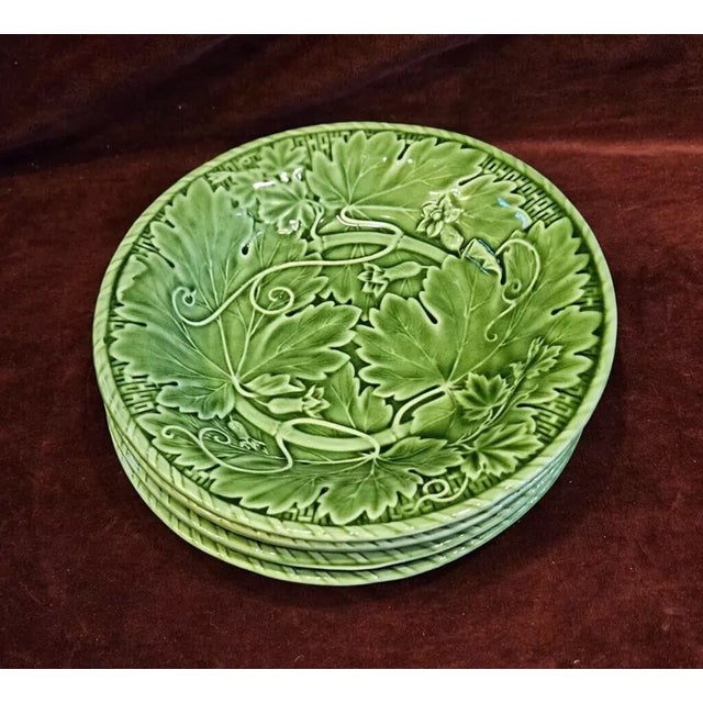 Beautiful set of four vintage Bordallo Pinheiro art pottery plates, showcasing the iconic craftsmanship and richly...