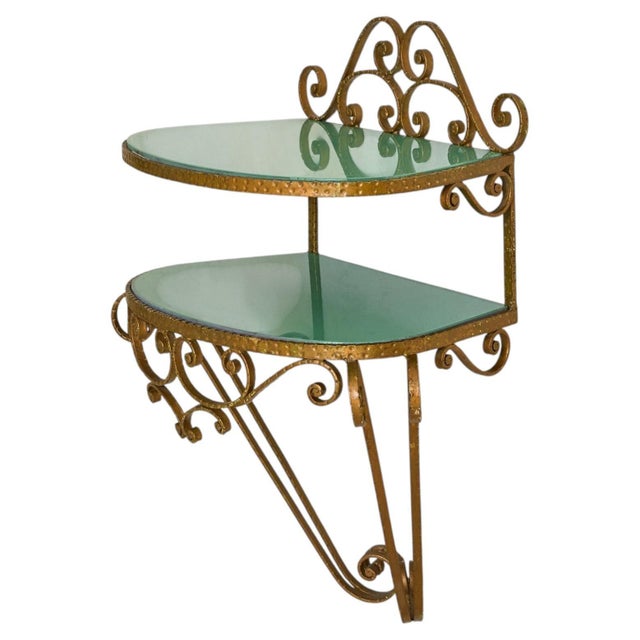 An Italian gilt iron wall-mounted console from the 1950s, crafted in the manner of Pier Luigi Colli. The frame is richly...