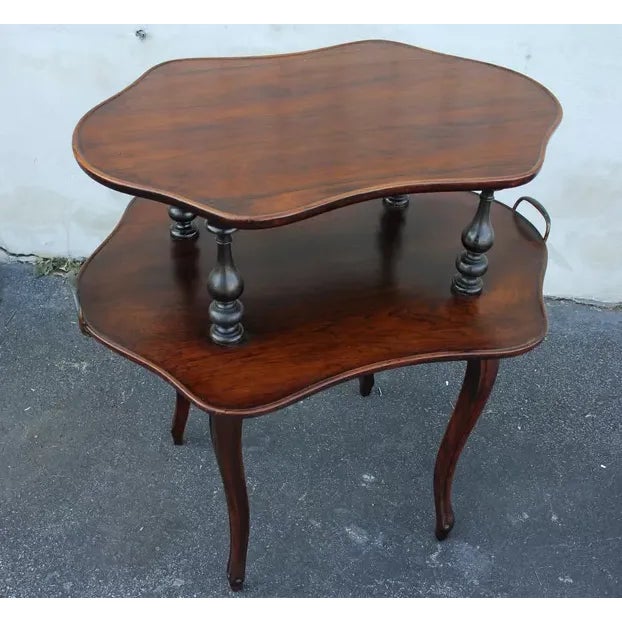Very unusual French rosewood server table featuring two shaped tops connected by decorative turned supports, with...