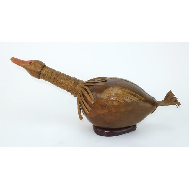 If it looks like a duck and quacks like a duck...it may be a decanter! Charming leather covered green glass decanter in...