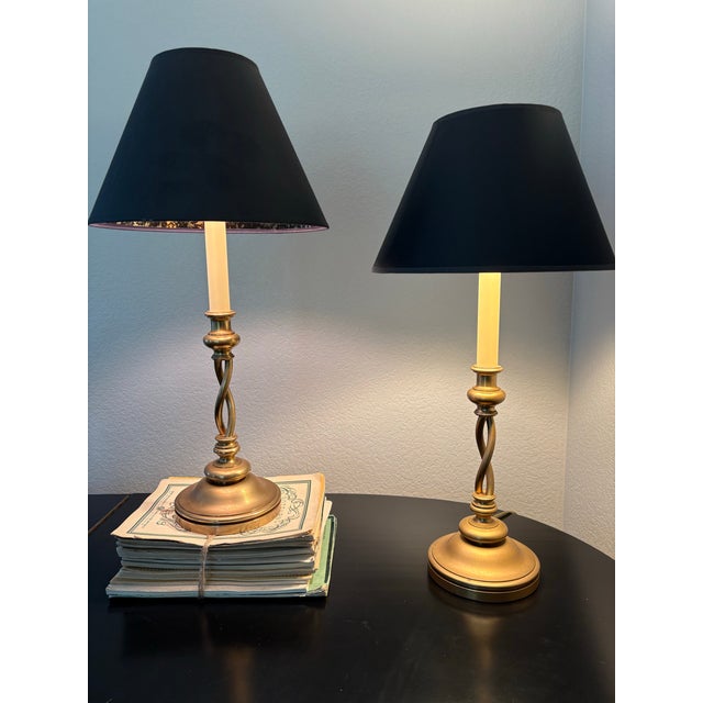 Handsome pair of Chapman Manufacturing candlestick table lamps featuring sculptural barley-twist columns, warm antiqued...