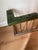 Nice English fireplace fender with a solid steel base and brass spindles. The seating is upholstered in green tufted...