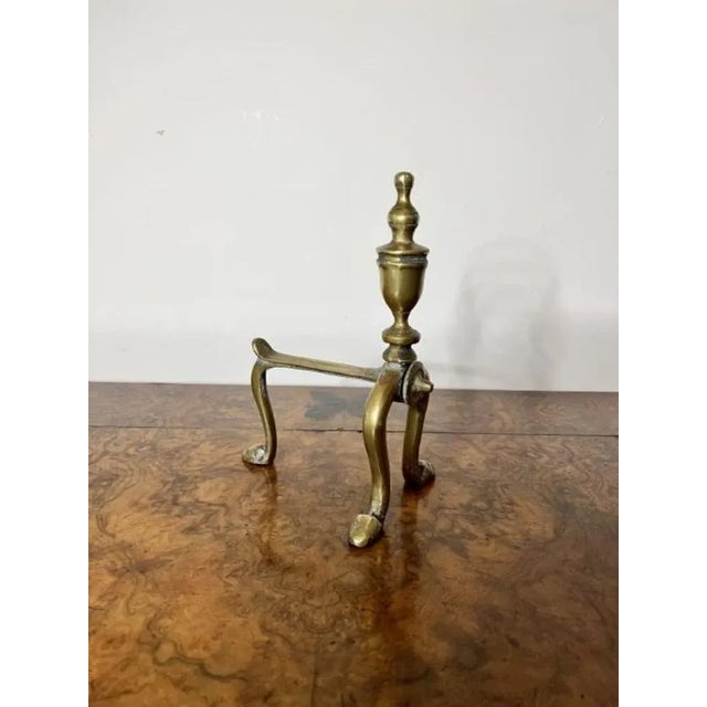 Elegant pair of quality antique Victorian brass fire dogs having a quality pair of brass fire dogs with shaped tops...