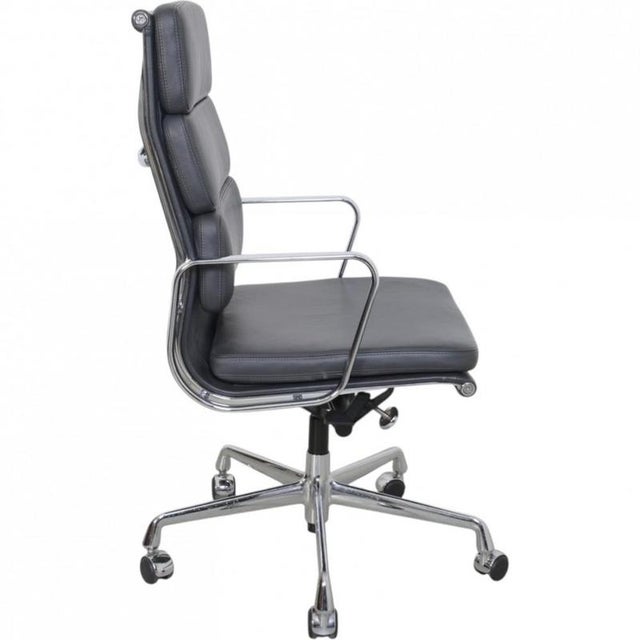 Charles Eames EA-219 office chair upholstered in grey leather, with chrome armrests and a chrome base. The chair is from...