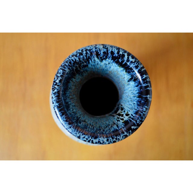 This baluster-shaped vase in glazed stoneware is characteristic of the 1960s. Its silhouette is enhanced by two small,...