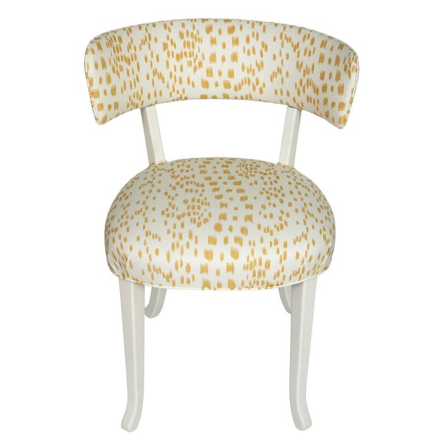 A set of four Klismos style white painted dining chairs, with seat and backs newly upholstered in yellow Les Touches...