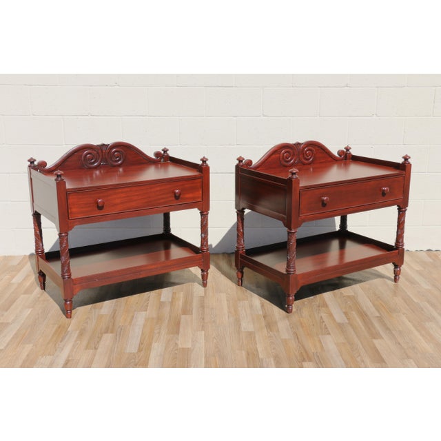 A beautifully crafted pair of British Colonial style two-tier stands by Ralph Lauren, executed in rich mahogany with...