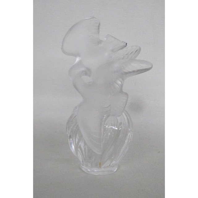 This lovely empty perfume bottle is made out of glass and crystal. The bottle is etched on the bottom as having been made...