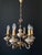 The chandelier is made of brass and bronze. It’s adorned with beautiful ceramic elements featuring floral decor created...
