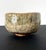 A modern ceramic Chawan (Tea Bowl) by potter Kato Tokuro (1896-1985). The bowl was hand-molded in the classic Han-tsutsu-...