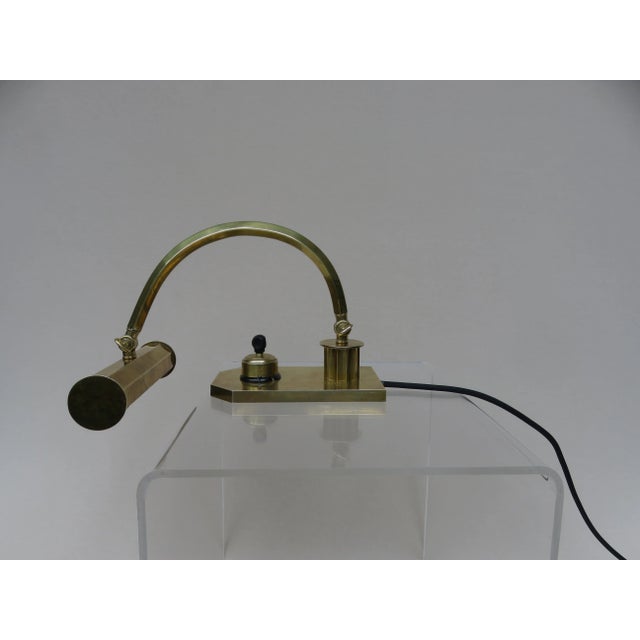 A piano lamp from the Art Deco period in polished brass. The lamp has an E14 socket. Due to the 2 joints the lamp is...