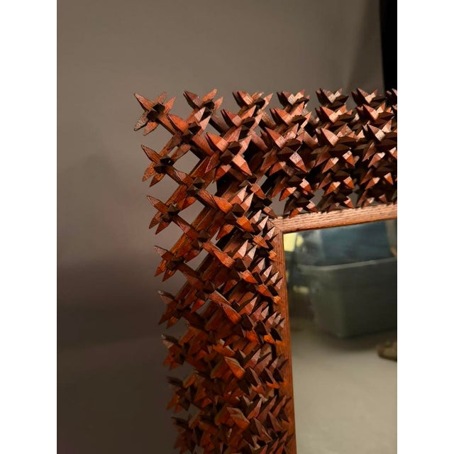 Distinctive early 20th-century American folk art mirror frame, dating to circa 1920s, featuring a highly dimensional...