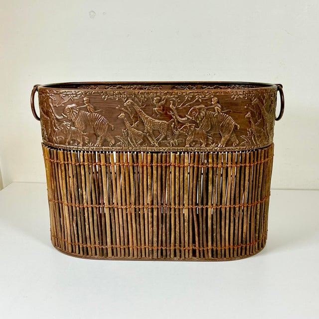This is a fun and chic tole metal wastebasket from the 1980s. It features elephant, monkey and Giraffe raised images on an...