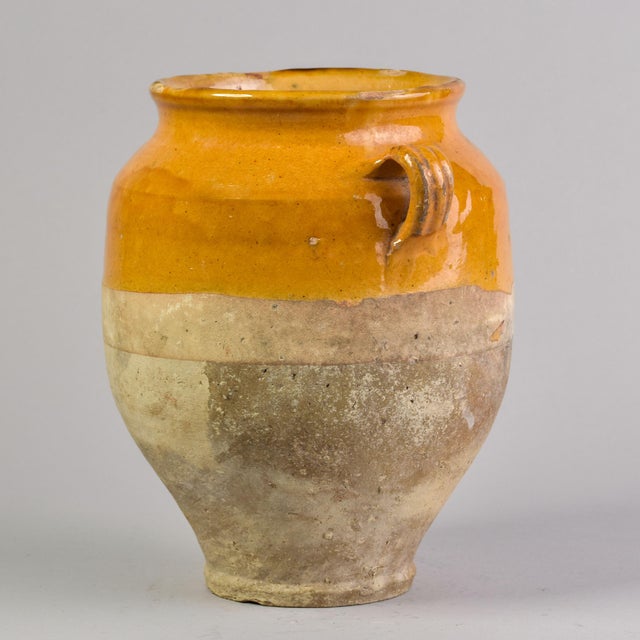 Found in France, this classic French confit jar with handles dates from approximately 1910. Outside bottom of ceramic jar...