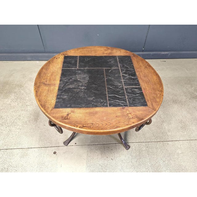 Vintage coffee table designed by René Drouet (1899–1993). The table has a gilded wrought iron base and a wooden and slate...