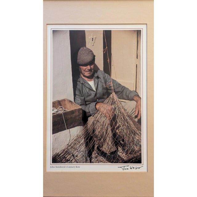 Photography By Tom Weber "John Steinbeck's Cannery Row". Framed, Matted. 1980s.Measurements: 12" x 15.5" Good vintage...