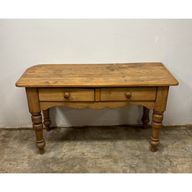 This 19th century English pine prep table is a piece of history both made and lived in, carrying the marks of a century...
