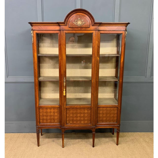 An attractive Edwardian period display cabinet. Made in England but in the French style. Very well constructed in walnut...