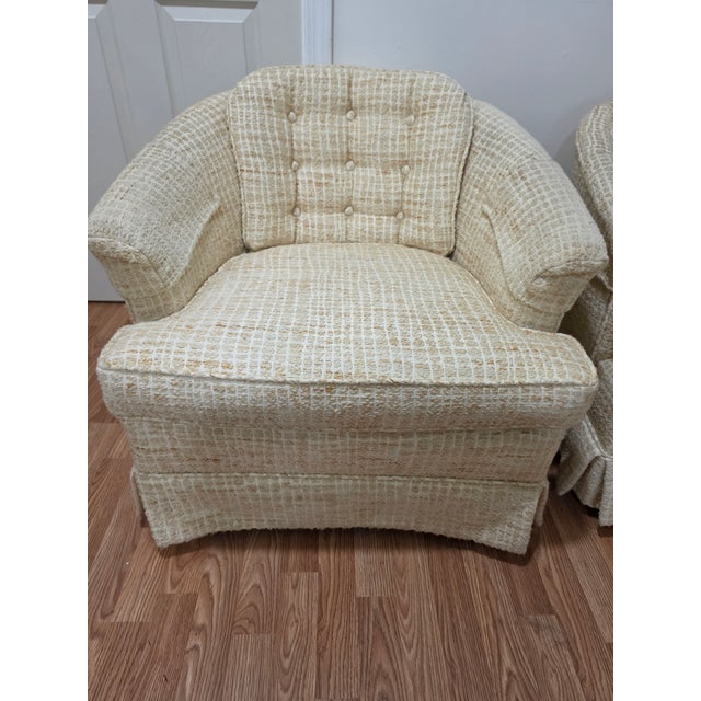 This exceptional matching pair of unbranded Mid-Century Modern swivel barrel chairs beautifully balances iconic atomic-era...