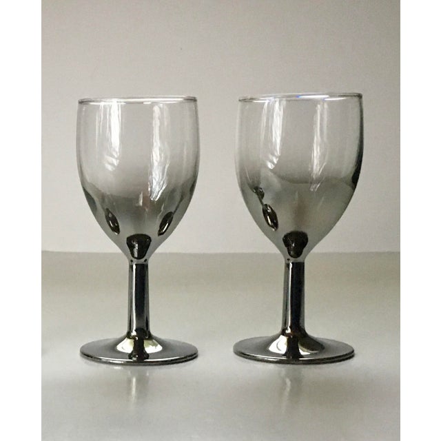 A pair of small silver dipped wine glasses which fade upward to clear glass and hold four ounces each. Ships within 1-2...