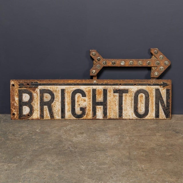 A 20th century english cast iron enamel advertising sign, finished in black and white enamel, showing directions to...