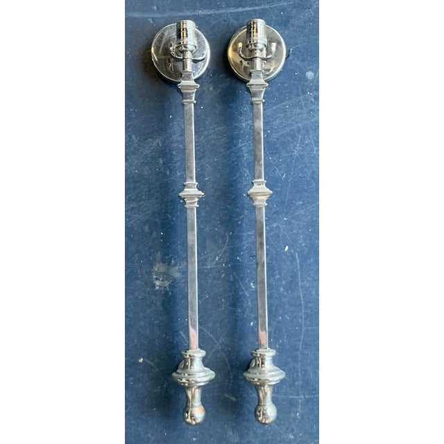 This striking pair of wall sconces epitomizes the refined elegance of Regency-inspired lighting, offering a sophisticated...
