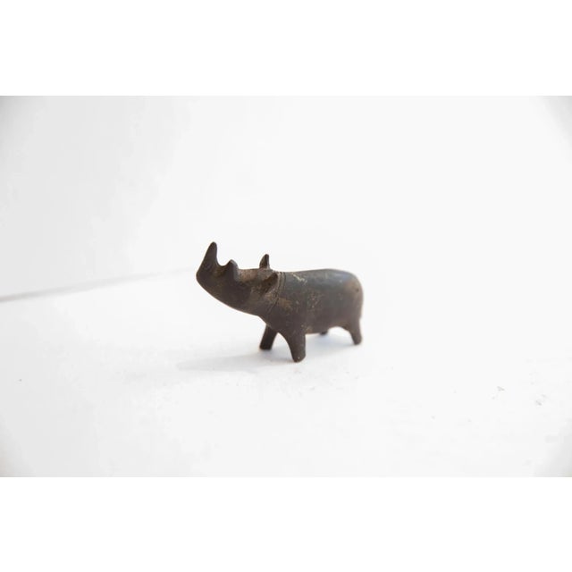 :: Vintage handmade African dark patina rhino figurine. Circa mid 20th century, though possibly older, this piece has such...