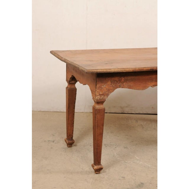 An Italian rustic carved-walnut farm table from the turn of the 18th and 19th century. This antique table from Italy has a...