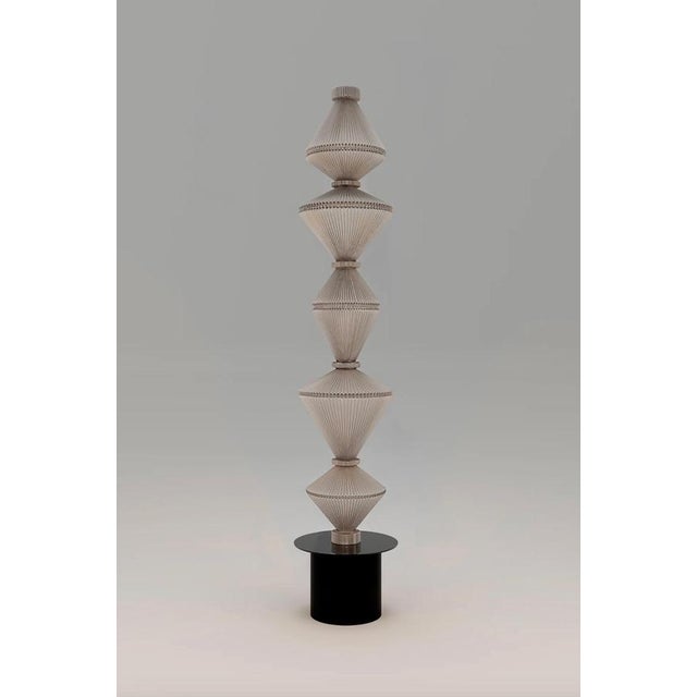 Atelier oï oïphorique p pe floor lamp for parachilna oïphorique displays an elegant textile diffuser. After turning on the...