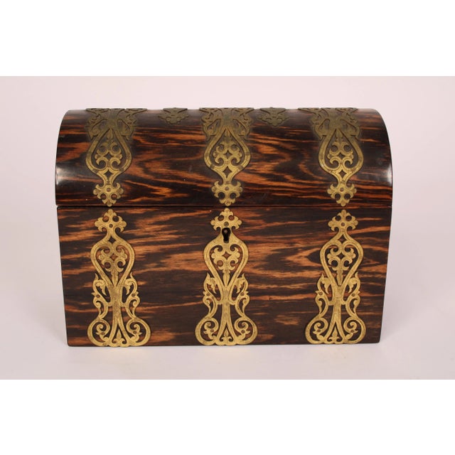 Antique calamander wood brass mounted domed shaped trinket / jewelry box, circa 1900. With engraved brass mounts and...