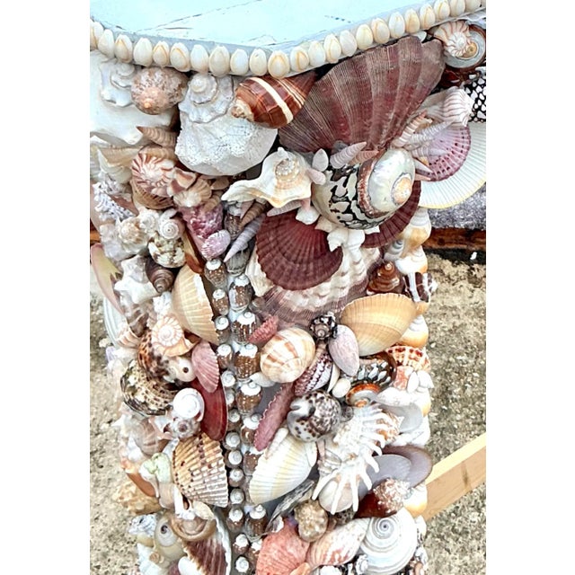 Transform your living space into a serene coastal retreat with this remarkable vintage Boho shell-encrusted fireplace...