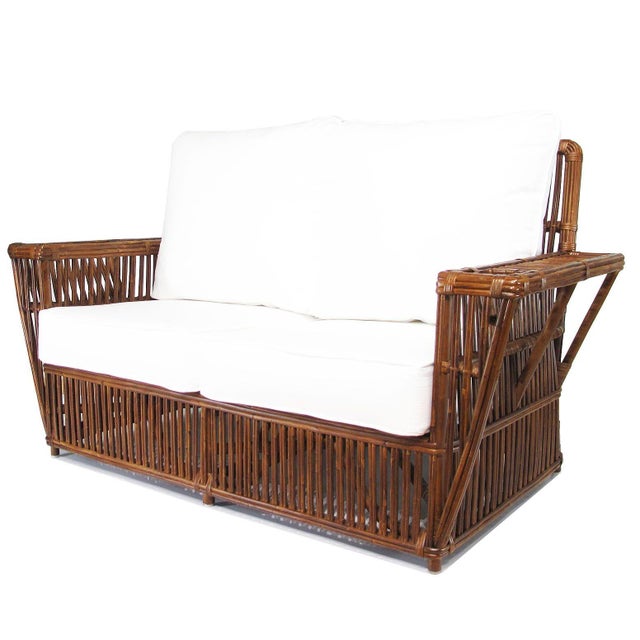 This beautifully stick rattan “Nantucket” settee features classic Walnut Finished stick rattan framing with tightly woven...