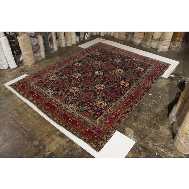 An antique 10x15 Persian rug from Tehran, hand-knotted in wool circa 1920s. Further On the Design: This antique piece is a...