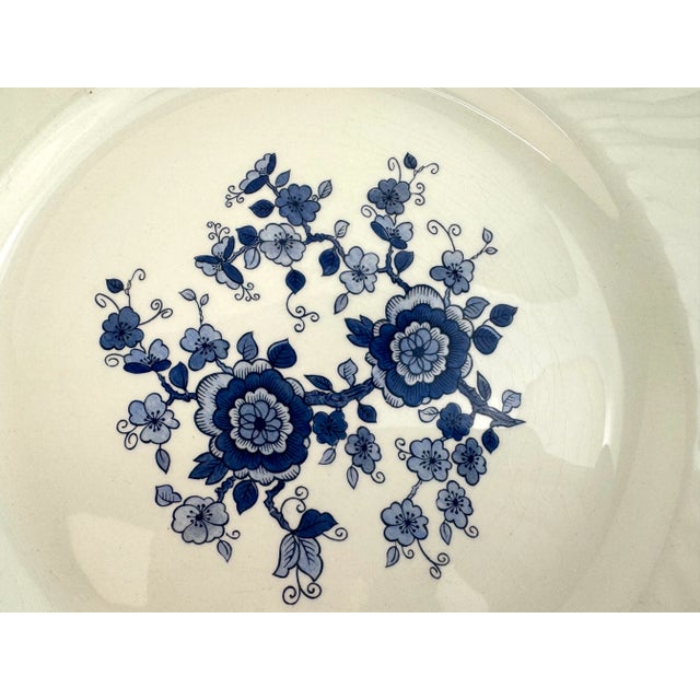 A refined set of eight dinner plates by Enoch Wedgwood (Tunstall) Ltd. in the "Royal Blue Ironstone" pattern, featuring a...