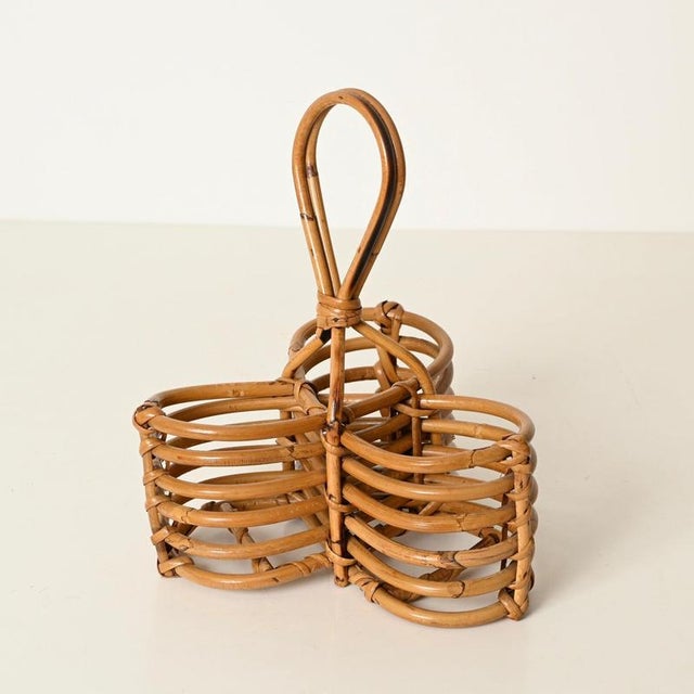 Stunning and highly decorative Mid-Century French Riviera style wine rack in curved rattan and hand-woven wicker. This...