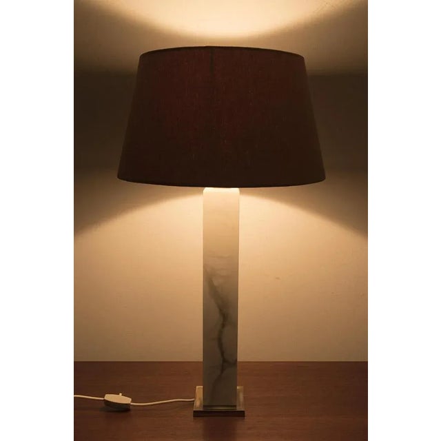 Wonderful White Marble Table Lamp with Brass Detail on the Base and a Yellow Shade. In good vintage condition....