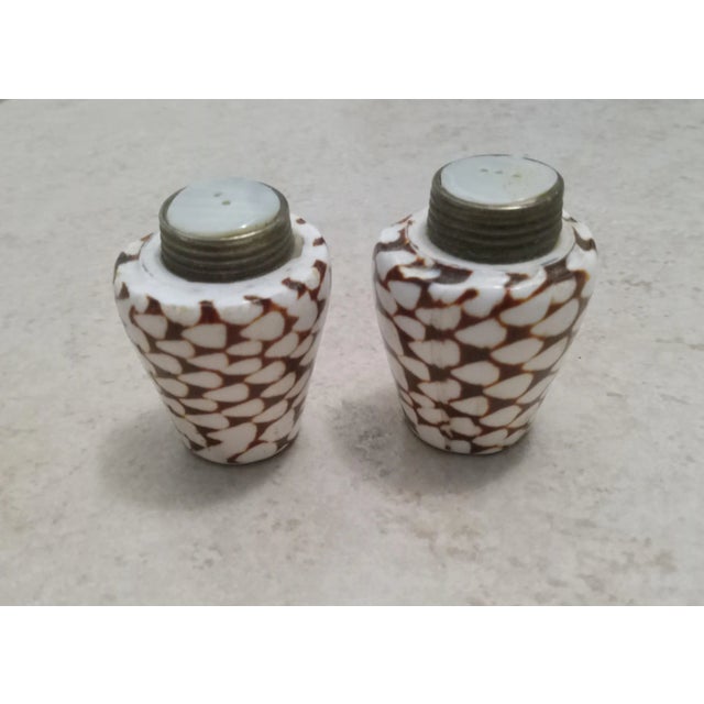 Add a touch of whimsy to any tabletop with these vintage seashell salt & pepper shakers - mother of pearl top. In very...