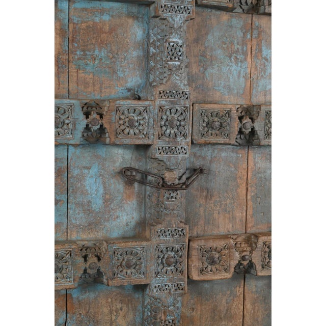 Antique Indian Carved Teakwood Door on Iron Stand, late 19th century, from Gujarat. The frame, center and panel dividers...