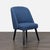 This chair with a hardwood frame features a wraparound back upholstered in welted fabric and thin tapered legs. Brand:...