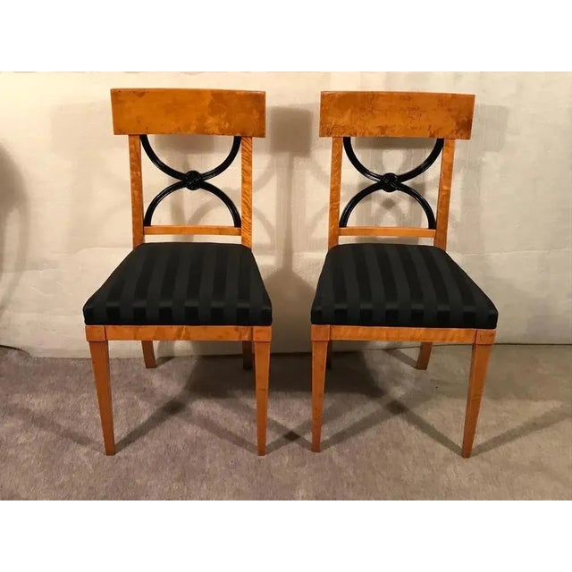 Add timeless elegance to your space with these Biedermeier chairs, dating back to around 1825. Each chair features a...