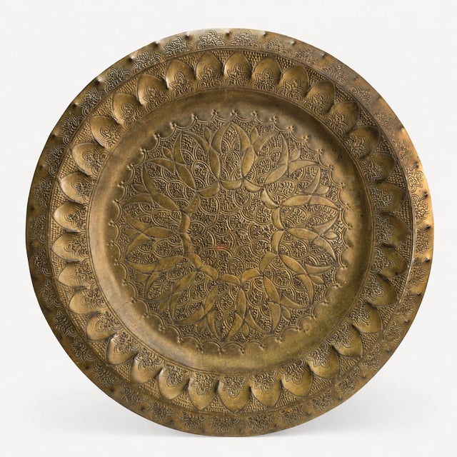 Large vintage brass decorative tray with a richly hand-tooled lotus medallion, aged patina, and an unidentified artisan...