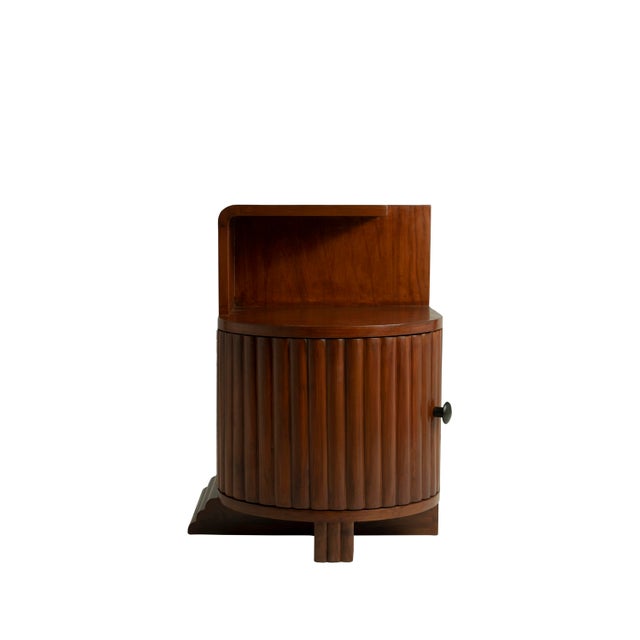 A pair of Mid-Century Modern teak side or end tables. Carved and curved fluted front doors with left and right entries....