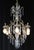 Louis XV style chandelier draped in clear pendeloque crystals, a brass scrolled frame, and an etched crystal ball shaped...