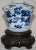 Blue hand-painted details accent this unique white Asian ceramic vessel. It is marked on the bottom of the piece. The...